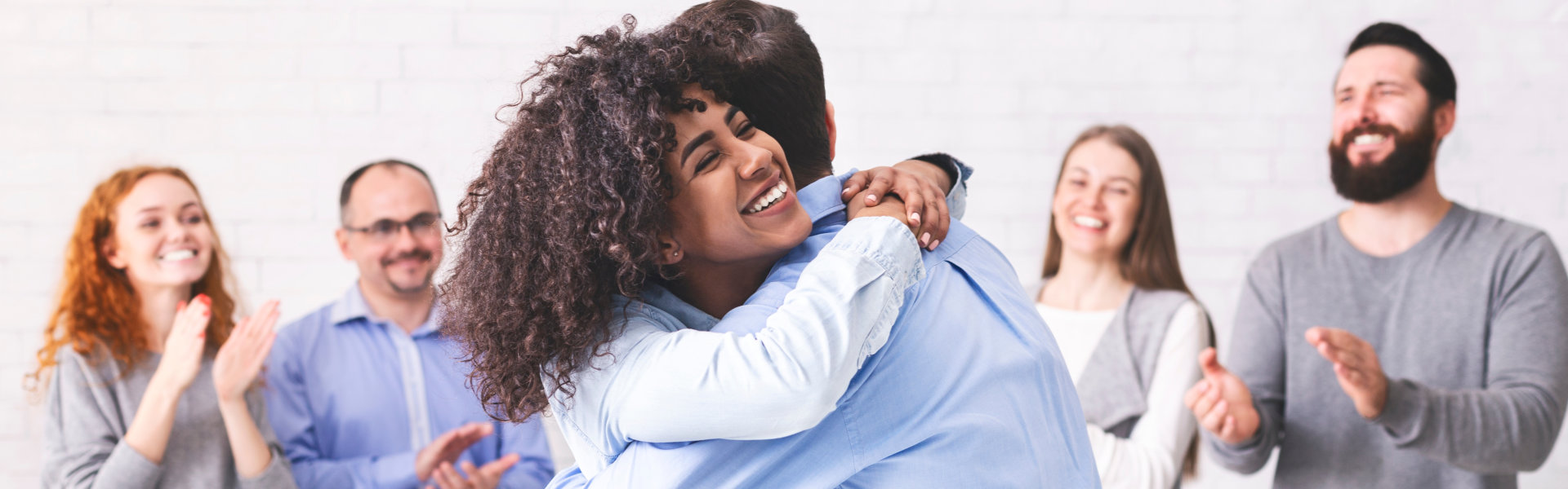 young man and woman hugging