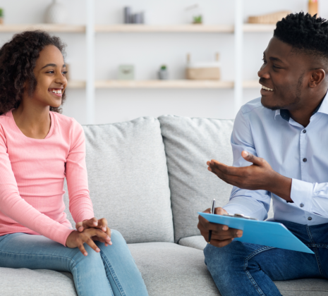 psychiatrist talking to a kid smiling