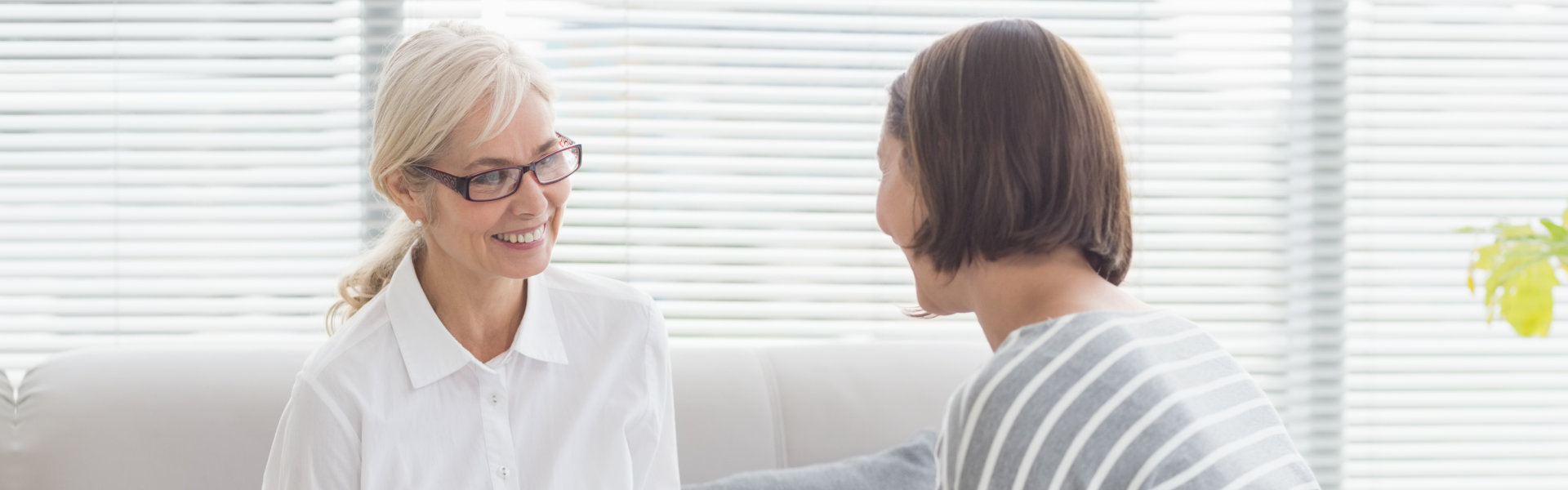 psychiatrist and young woman smiling to each other