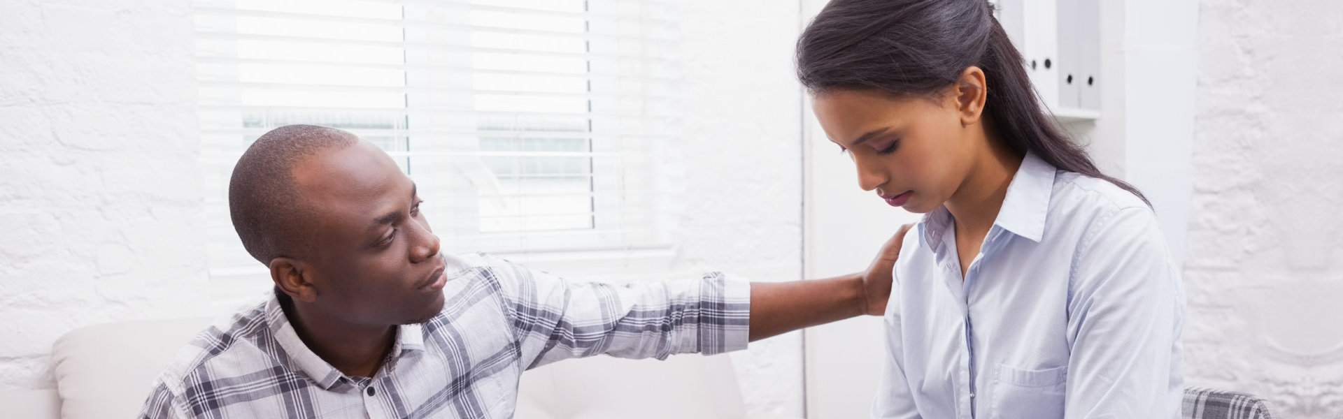 psychiatrist comforting the young woman